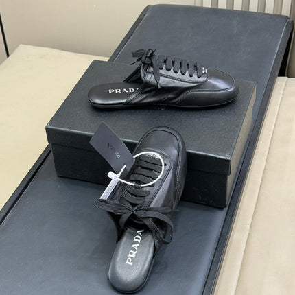 PRADA 25S COLLAPSE MULES IN BLACK CALFSKIN