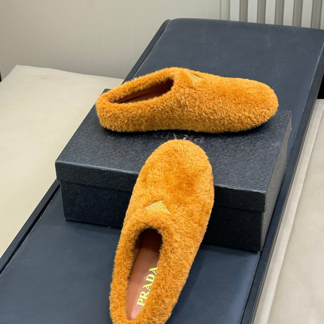 PRADA 25S CLOGS IN DARK ORANGE SHEARLING
