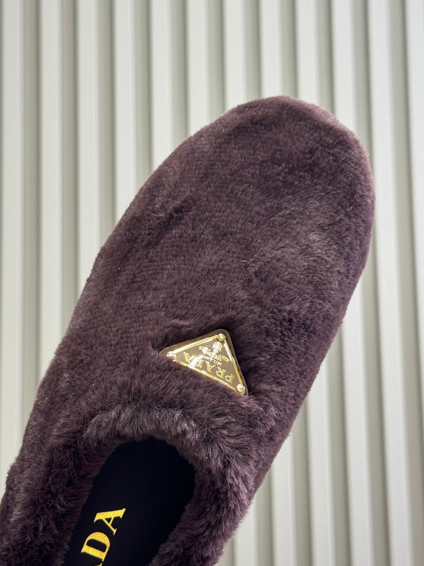 PRADA 25S CLOGS IN WINE RED SHEARLING