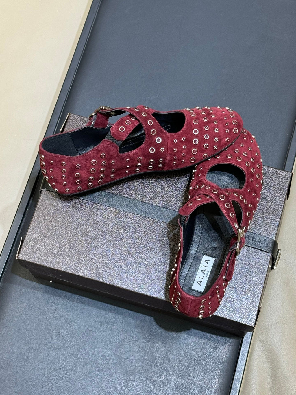 ALAIA 26S CROSS-STRAP FLATS IN DARK RED SUEDE WITH SILVER HARDWARE