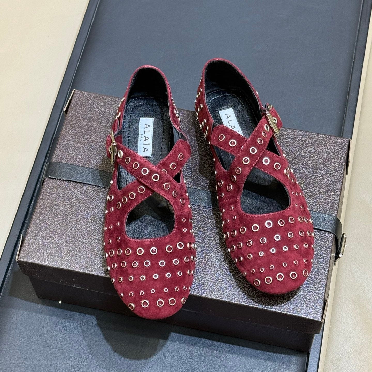 ALAIA 26S CROSS-STRAP FLATS IN DARK RED SUEDE WITH SILVER HARDWARE