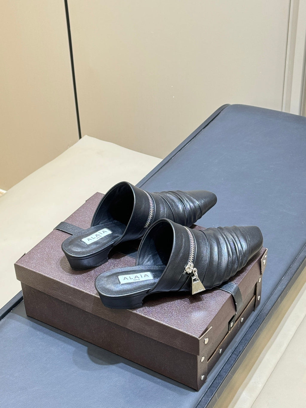 ALAIA 26S PLEATED MULES IN BLACK LAMBSKIN