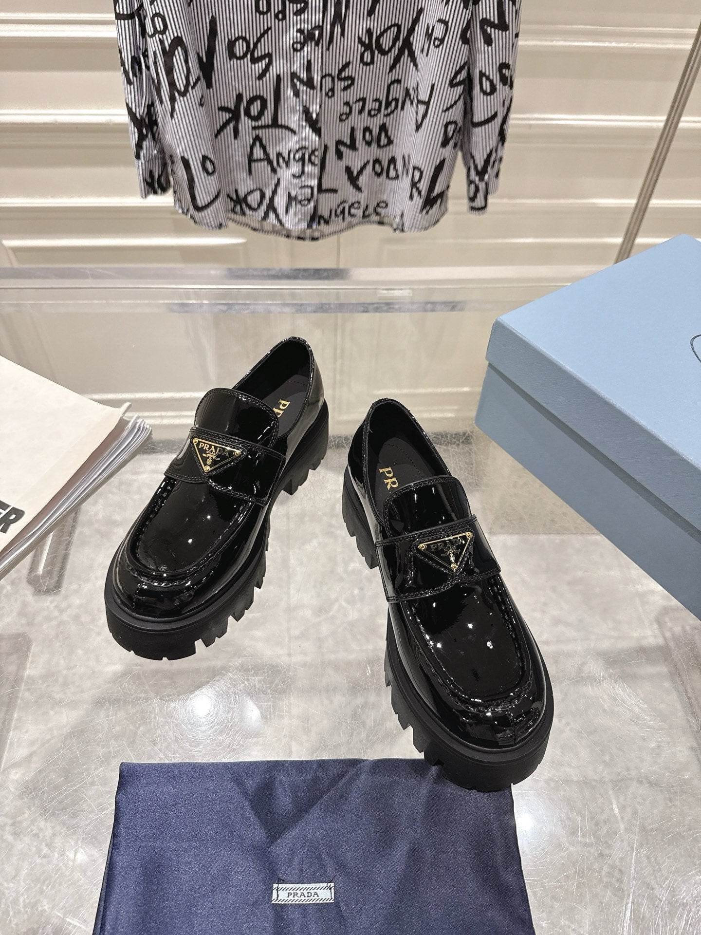 PRADA 26S PLATFORM LOAFERS 45MM IN BLACK PATENT CALFSKIN
