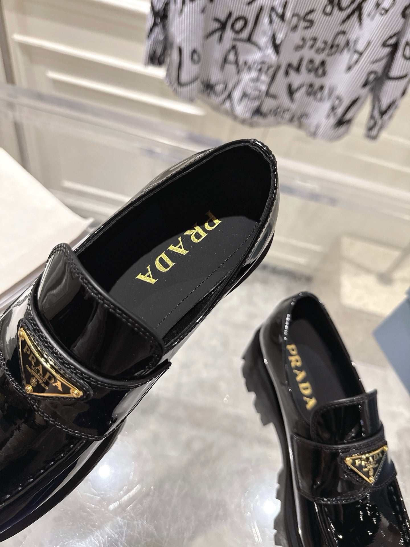 PRADA 26S PLATFORM LOAFERS 45MM IN BLACK PATENT CALFSKIN