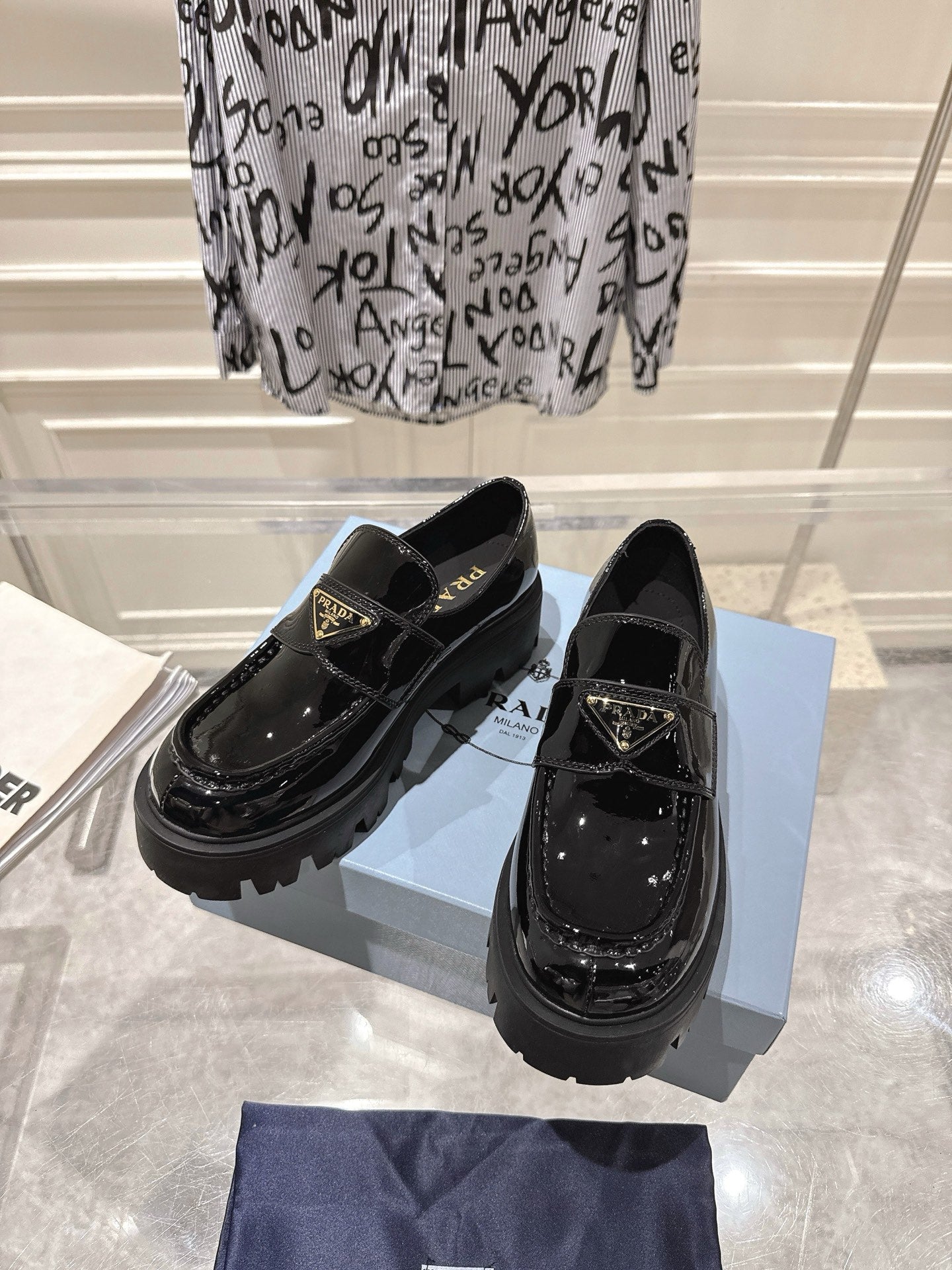PRADA 26S PLATFORM LOAFERS 45MM IN BLACK PATENT CALFSKIN