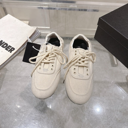 PRADA 26S COLLAPSE SNEAKERS IN WHITE CANVAS