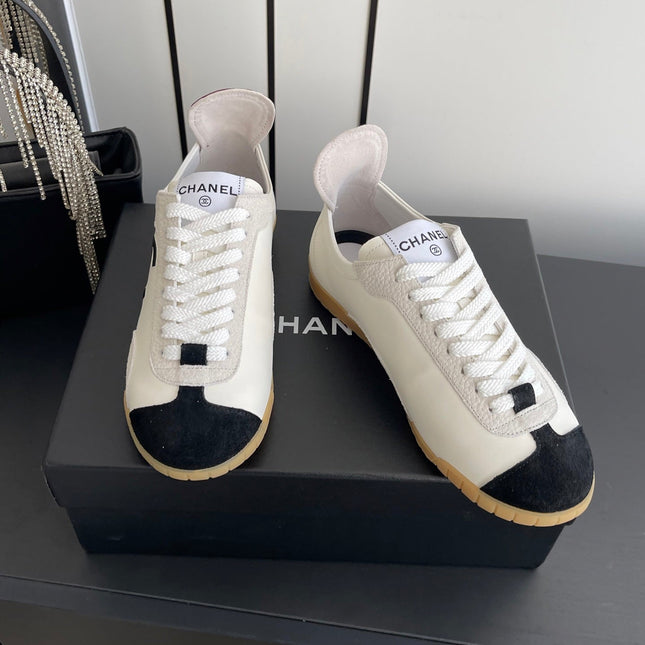 CHANEL LOW-TOP SNEAKERS IN BLACK AND WHITE CALFSKIN MIX SUEDE