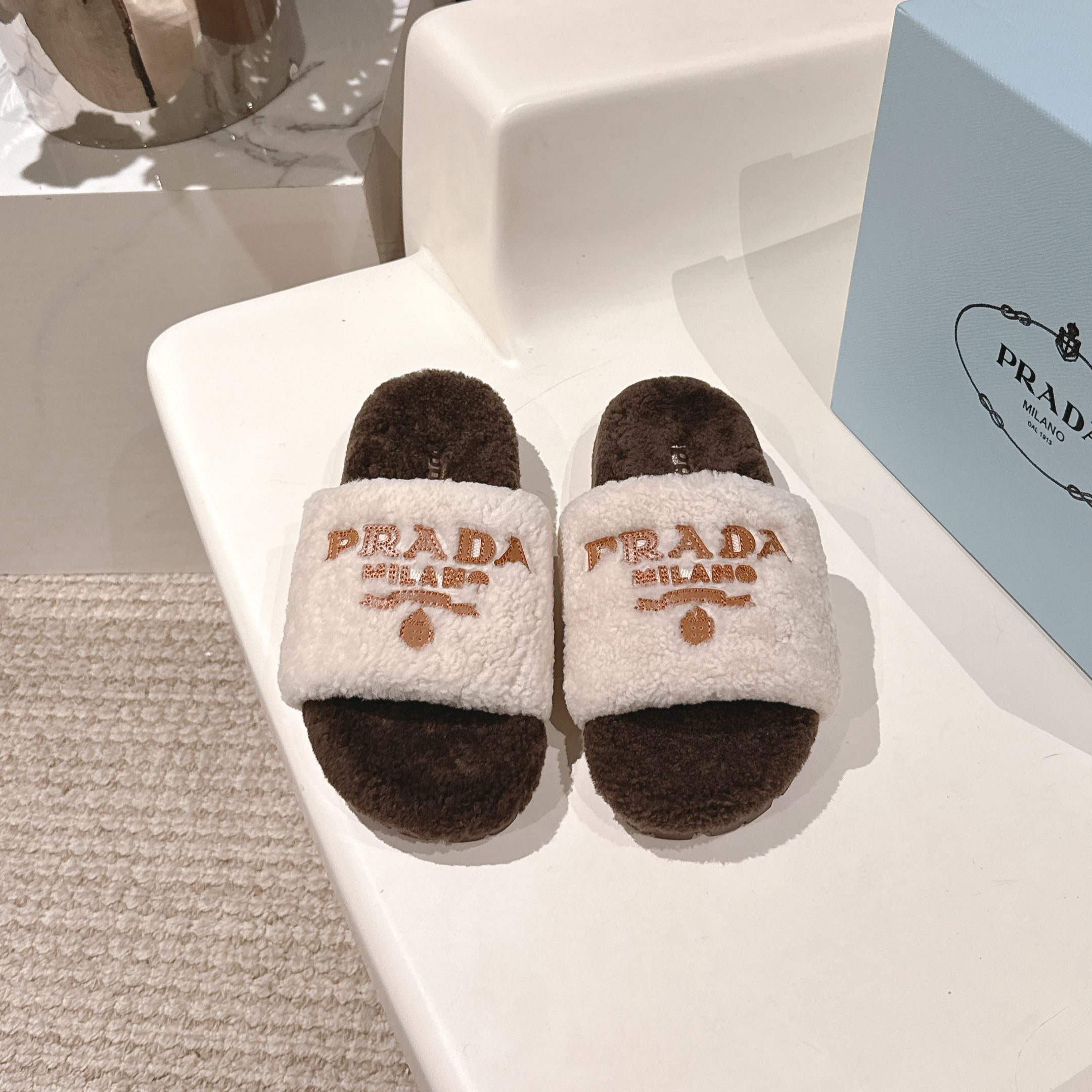 PRADA 25S FLAT MULES IN WHITE AND DARK BROWN RABBIT FUR