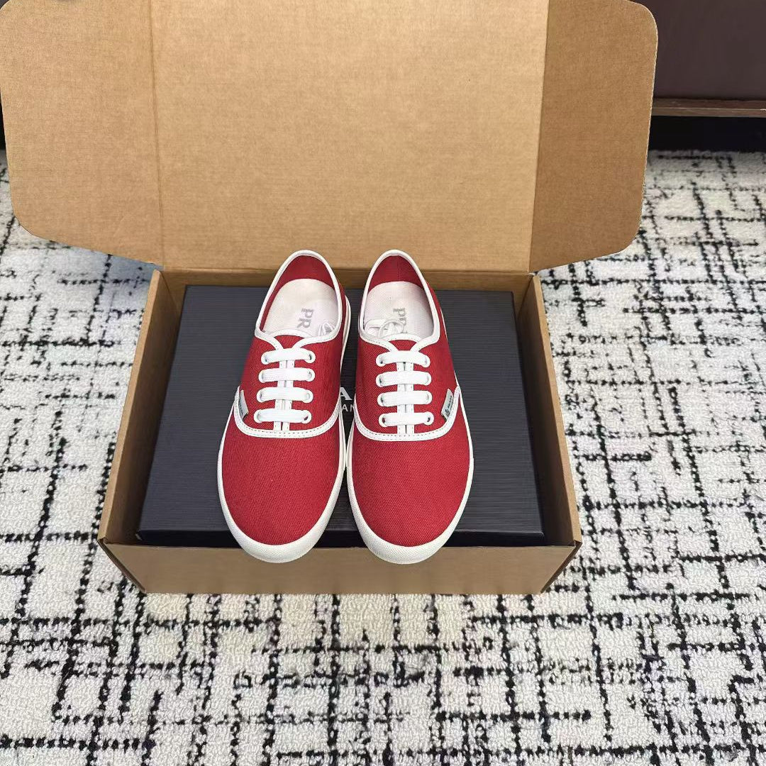 PRADA 26S LACE UP SNEAKERS IN RED CANVAS