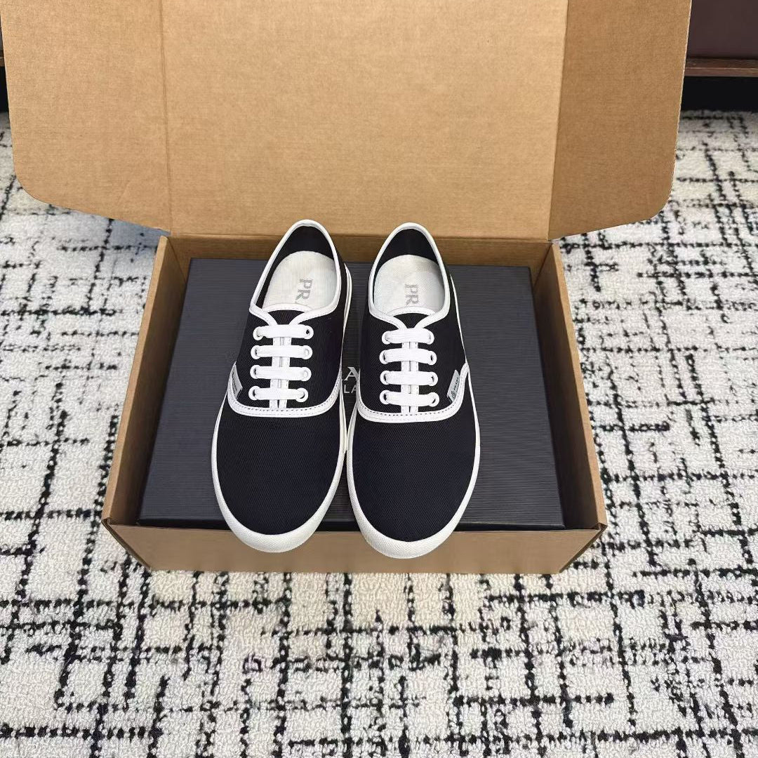 PRADA 26S LACE UP SNEAKERS IN BLACK AND WHITE CANVAS