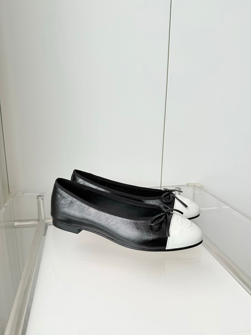 CHANEL 26S BALLET FLATS IN BLACK CRACKED CALFSKIN WITH WHITE TOE CAP AND BOW