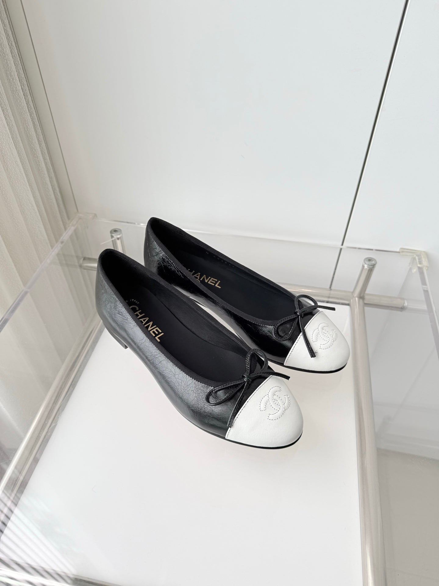 CHANEL 26S BALLET FLATS IN BLACK CRACKED CALFSKIN WITH WHITE TOE CAP AND BOW