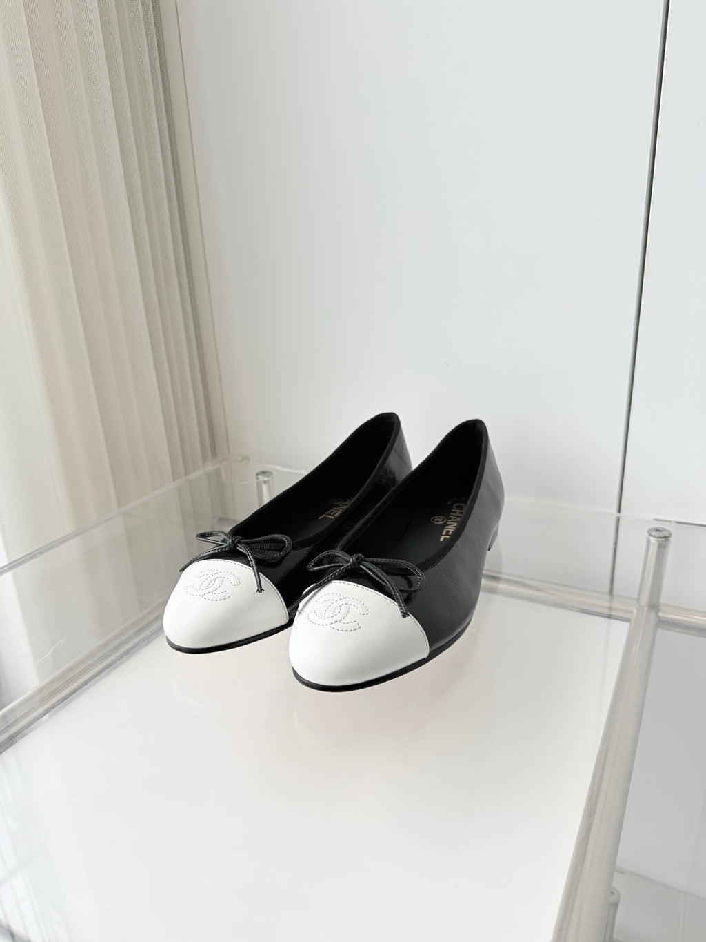 CHANEL 26S BALLET FLATS IN BLACK CRACKED CALFSKIN WITH WHITE TOE CAP AND BOW