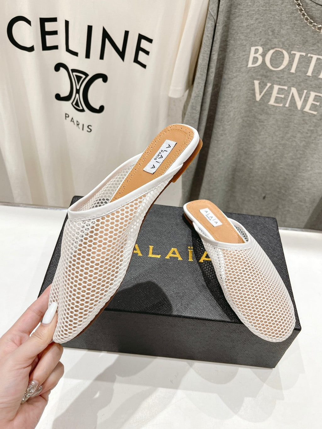 ALAIA FLAT MULES IN WHITE MESH FISHNET