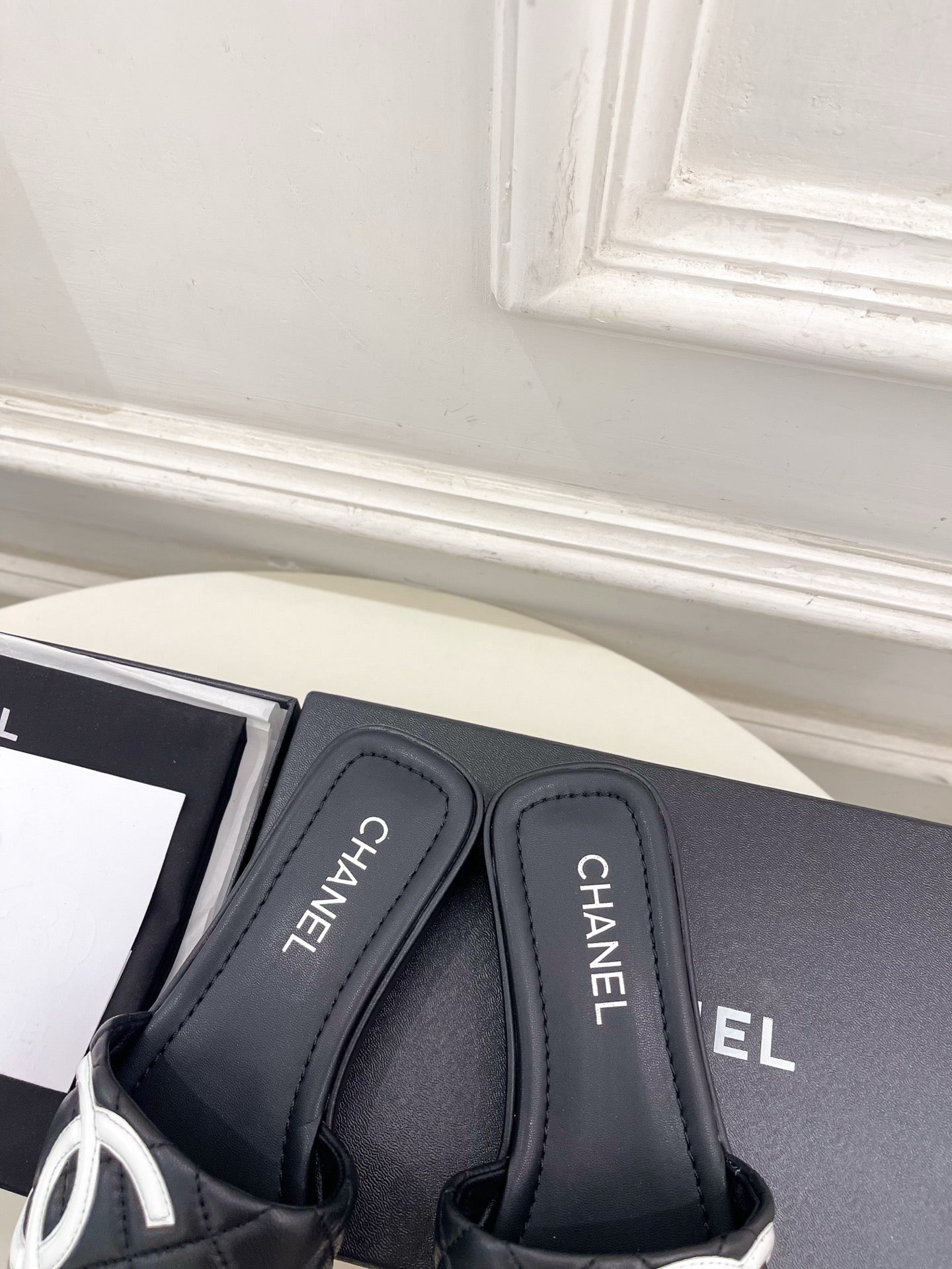 CHANEL 26S FLAT SLIDES IN BLACK LAMBSKIN WITH WHITE CC LOGO