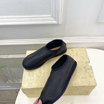 THE ROW 26S SLIP-ON FLATS IN BLACK NAPPA CALFSKIN